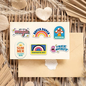 Close-up of vintage American style stickers with rainbow, mushroom and sun patterns