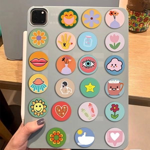 Detailed view of colorful cartoon sun and doodle stickers on a tablet back