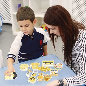 Detail of yellow aesthetic stickers being applied to a surface by a woman and a child