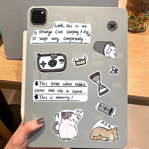 Close-up of cute Siamese cat stickers and hand-drawn patterns on a tablet surface