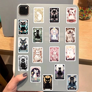Detailed view of cat tarot stickers with diverse designs on a tablet back
