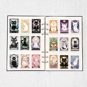 Detailed view of 18 cartoon cat tarot stickers organized in a white collector album