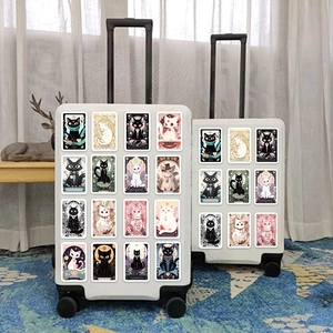 Detailed view of waterproof cartoon cat tarot stickers on a white travel suitcase