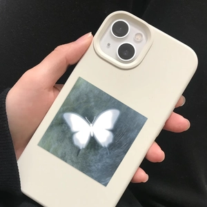 Close-up of cream beige matte silicone phone case with glowing butterfly design