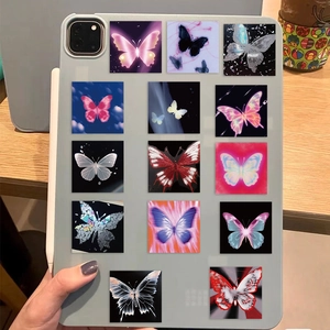 Close-up of vibrant butterfly stickers applied on a tablet case over a wooden desk
