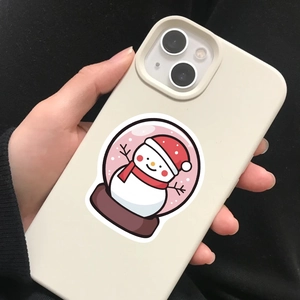 Detail of matte beige phone case with cute snowman sticker held in hand