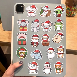 Close-up of 18 cute waterproof Christmas animal stickers on a grey tablet surface