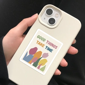 Detail of off-white matte phone case with GOOD THINGS TAKE TIME artistic sticker