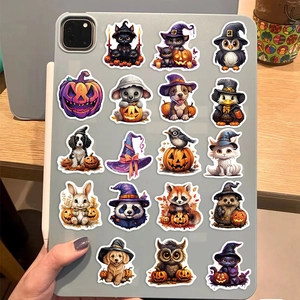Halloween cartoon stickers featuring black cats and pumpkins on a silver tablet case