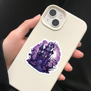 Detailed view of a purple gothic castle Halloween sticker applied on a white phone case