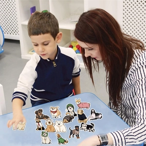 Adult and child selecting cute cartoon dog stickers on a blue desk for DIY decoration