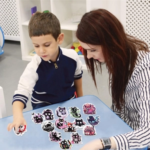 Interactive scene showing colorful waterproof cartoon cat stickers for DIY laptop decoration
