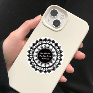 Close-up of gothic bible verse sticker on phone case with black mandala lace pattern