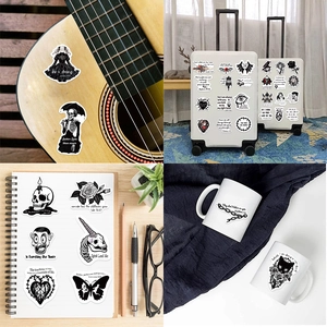 Detail of gothic bible verse stickers showing application on a guitar and suitcase