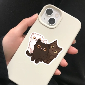 Close-up of cute cartoon cats on a matte beige iPhone case held in hand