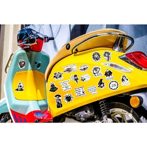 Close-up of gothic waterproof vinyl stickers with scripture applied on a yellow motorcycle