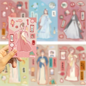 Close-up of hand holding vintage Hanfu girl stickers for DIY journaling decoration