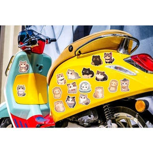 Cartoon cat stickers applied to a yellow vintage scooter for personalized DIY decoration