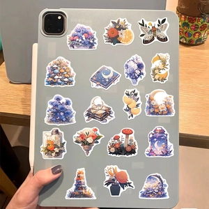Mystic flower and moon stickers applied on a tablet for creative DIY decoration