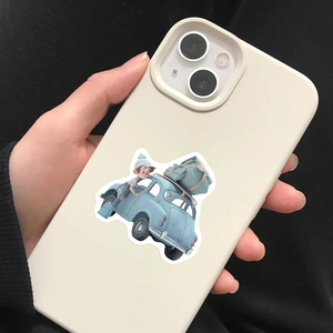 Detailed view of off-white iPhone case featuring 3D cartoon boy on a vintage car