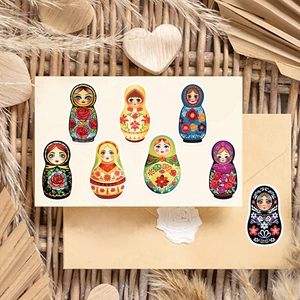 Artistic collection of Matryoshka doll stickers displayed on vintage envelopes and cards