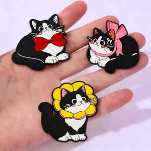 Three cute black and white cartoon cat enamel pins with colorful bows and sunflower collar