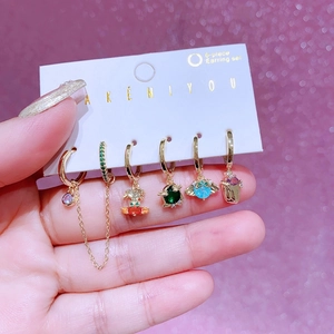 Colorful 6-piece earring set with gold hoops and various gemstone charms on display