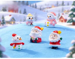 Miniature Christmas figurines set featuring Santa and snowmen on a winter snow scene background