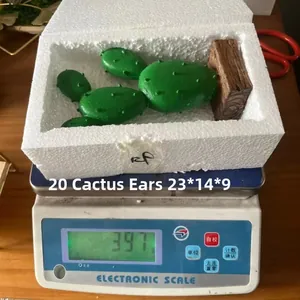 Close-up of decorative resin cactus ornament with faux needles and square wooden base