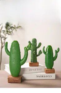 Close-up of Nordic style resin cactus figurines with realistic texture and wood base