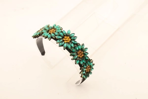 Detail of sunflower headband with emerald rhinestones and amber crystal centers