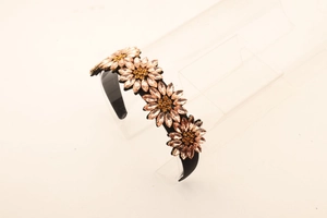 Detail view of sunflower rhinestone headband with sparkling champagne crystal petals