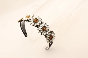 Macro shot of rhinestone flower headbands featuring amber and clear crystals details