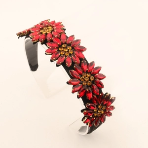 Luxurious wide headband featuring five red and orange crystal sunflowers on a black base