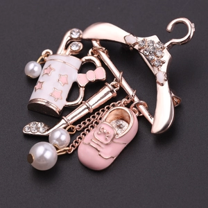 Detail of rose gold golf charm brooch with pink enamel shoe and pearl accents