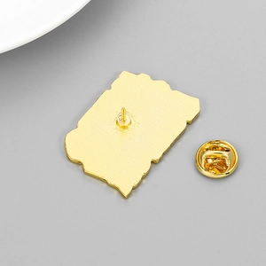 Polished gold metal badge back view with butterfly clutch and sharp pin detail