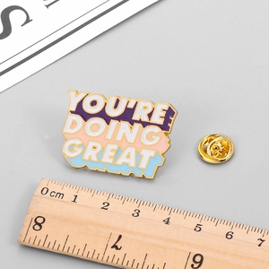 Inspirational 'You're Doing Great' enamel pin with colorful stripes and gold trim