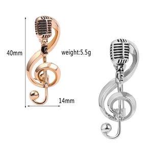 Detailed view of rose gold and silver music brooches with dimensions and weight specs