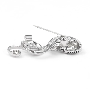 Detailed back view of silver brooch showing polished surface and secure safety pin clasp