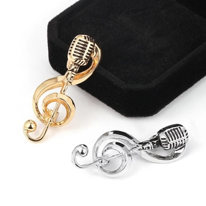 Vintage microphone and musical note brooch in polished gold and silver finishes