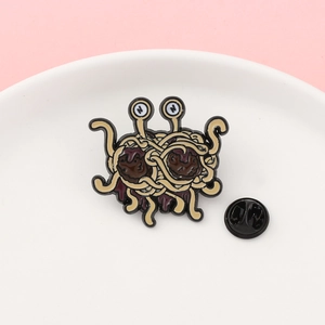 Detailed view of the Flying Spaghetti Monster enamel pin with rubber back clutch
