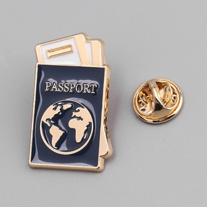 Detail of passport enamel pin with gold outline and dark blue finish with metal back