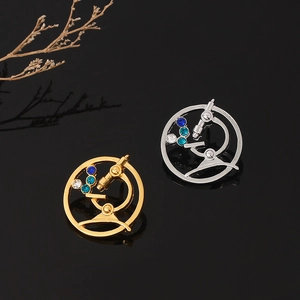 Detailed close-up of microscope brooches in gold and silver finish with crystal rhinestones
