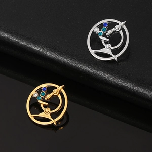 Detailed view of gold and silver microscope brooches with sparkling blue rhinestones