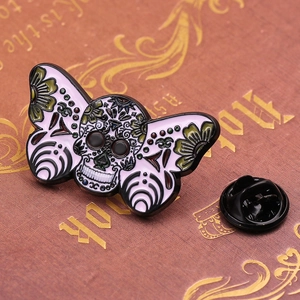 Halloween moth skull enamel pin with sugar skull design and black rubber backing