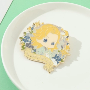 Detail of Chibi anime enamel pin with blue flowers on a white ceramic plate