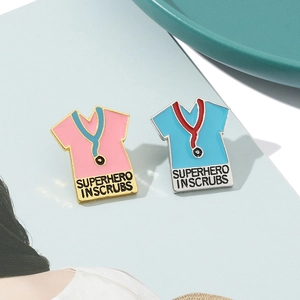 Enamel stethoscope brooch set with Superhero In Scrubs text on a ceramic tray