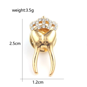 Detail shot of golden tooth brooch with crown rhinestones showing 2.5cm height