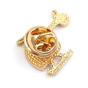 Detail view of gold-plated metal brooch back with butterfly clutch and textured finish