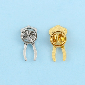 Detail view of gold and silver metal enamel pin backs with butterfly clutch fasteners